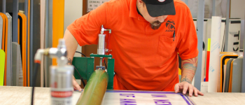 ADOT technician making a road sign.