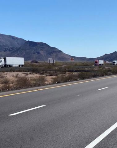 Repaved lanes of Interstate 10 between Salome Road and Tonopah, showing smooth asphalt, desert landscape, and distant mountains after pavement rehabilitation work.