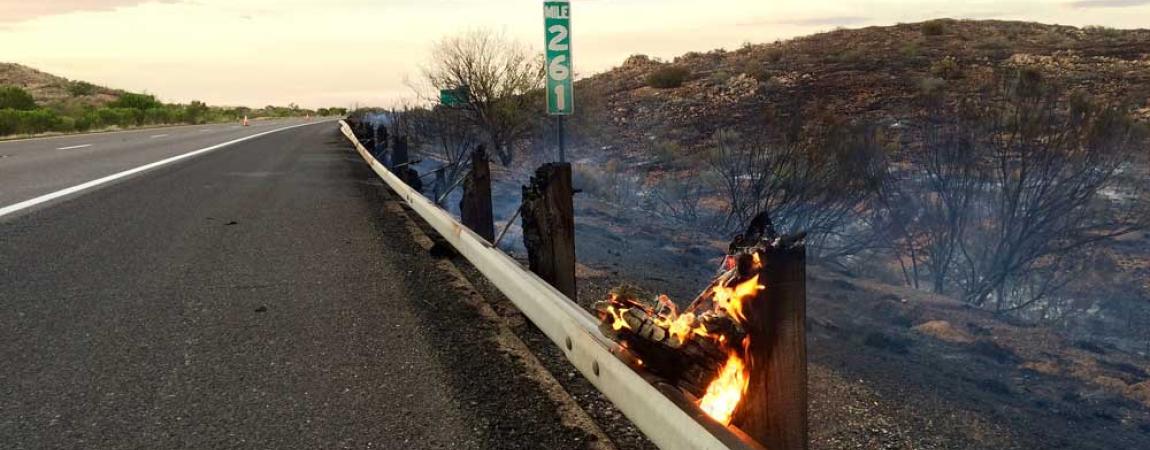 highway guard rail post on fire