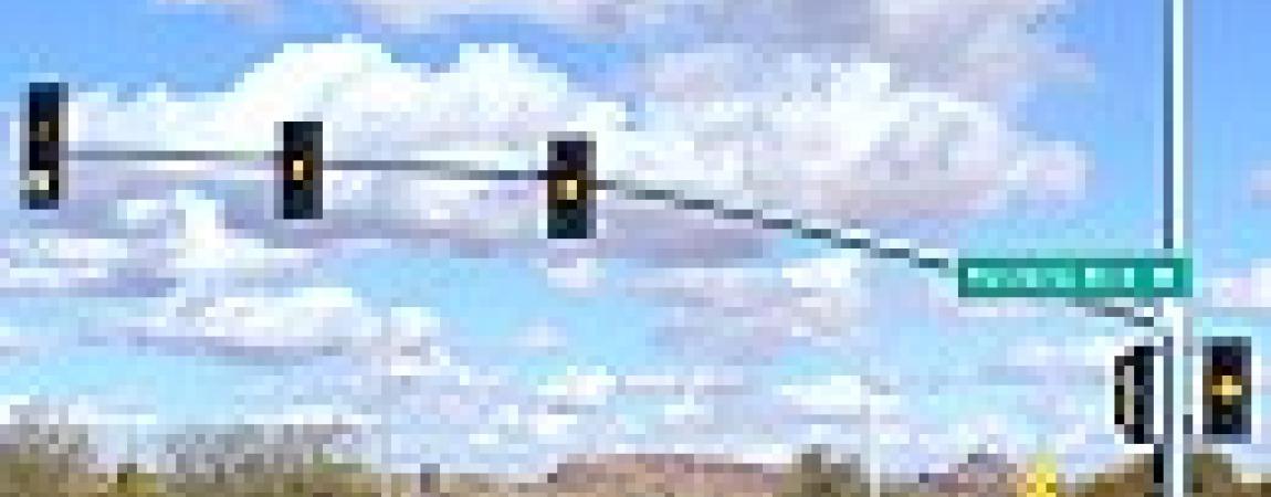 traffic signals with a cloudy sky background