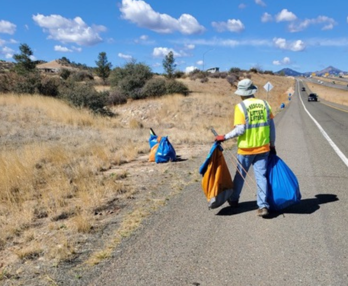 An Adopt a Highway volunteer collects litter