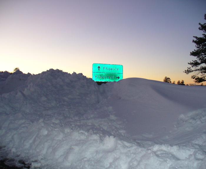 Snow bank with highway sign