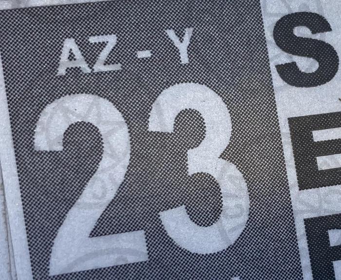 A vehicle registration sticker on a license plate.