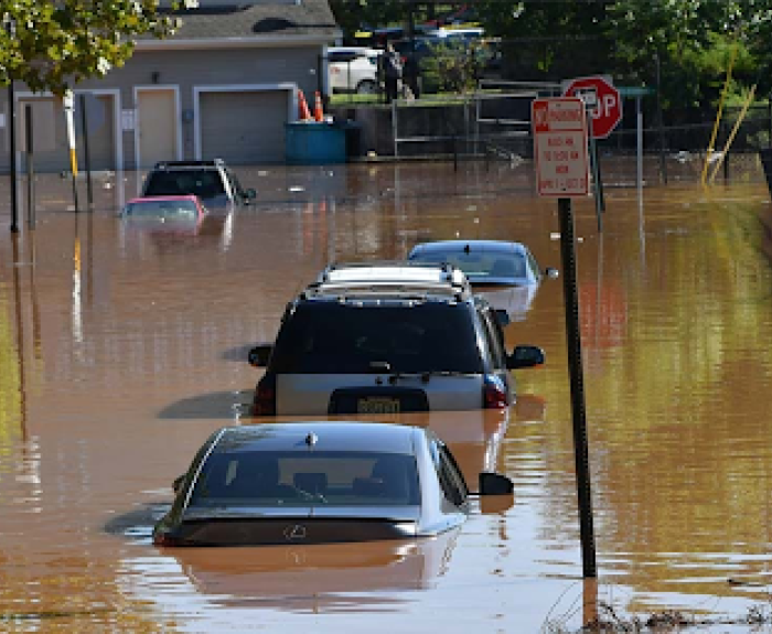 A flooded street with submerged cars.