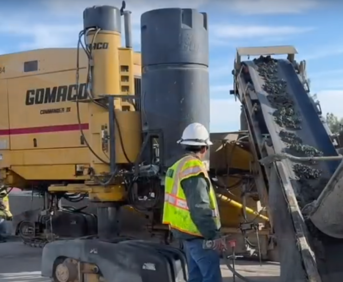 Crews preparing for using the slipforming method to build a concrete barrier