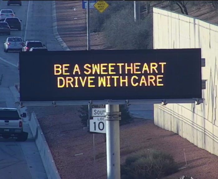 A digital message board on the highway encourages motorists to drive with care.