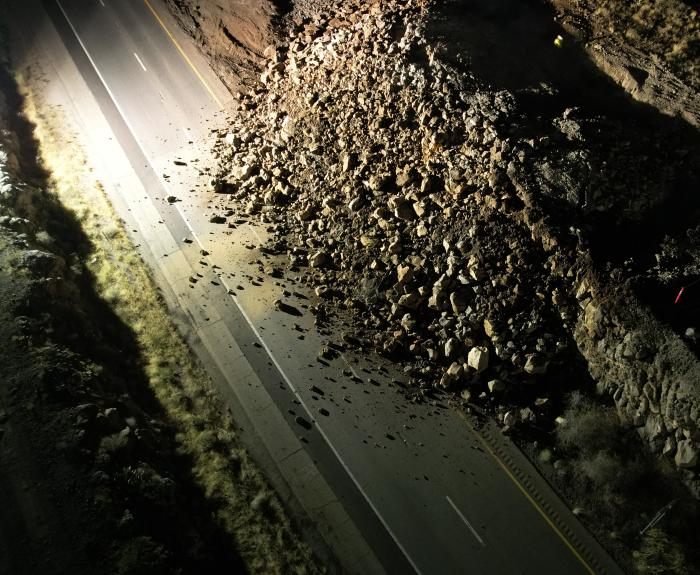 Rock covers a highway after rock blasting.