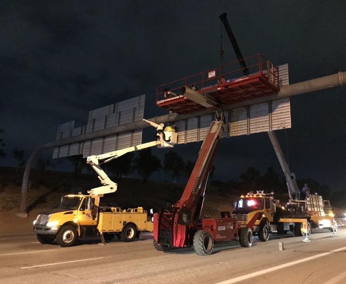 Work tucks block a highway. 