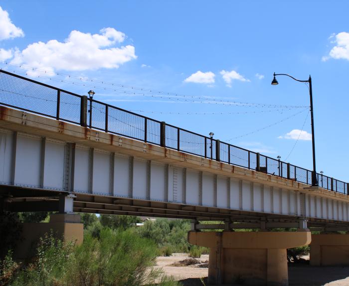 A picturesque bridge spanning a tranquil river, surrounded by lush greenery