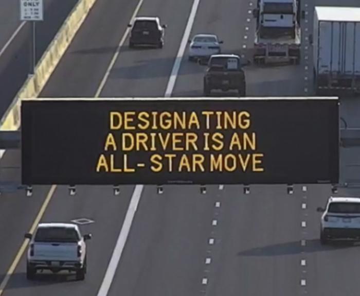 A digital message board on the highway encourages motorists to designate a driver.