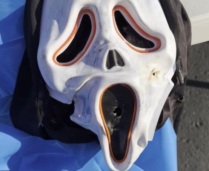 A white mask of a ghost typically associated with the "Scream" movie franchise.