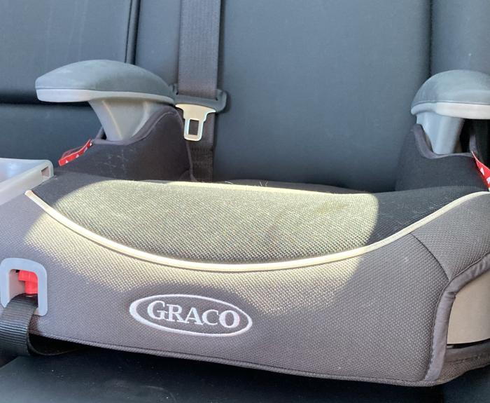 A booster seat inside a car. 