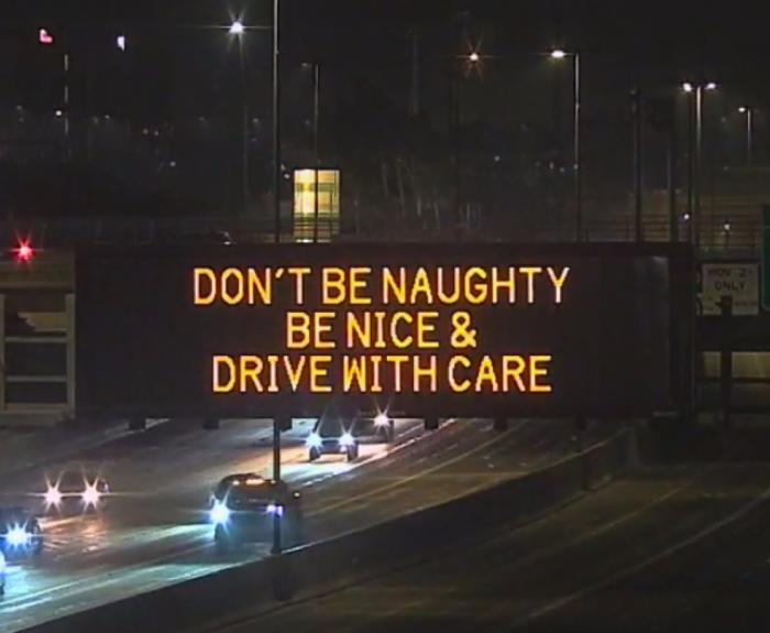 A digital message board on the highway encourages motorists to drive with care.