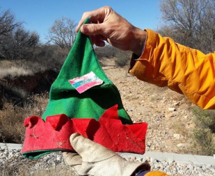 A person holds an elf hat.