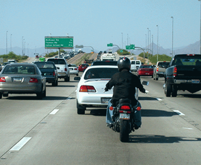A motorcyclist driving on the highway
