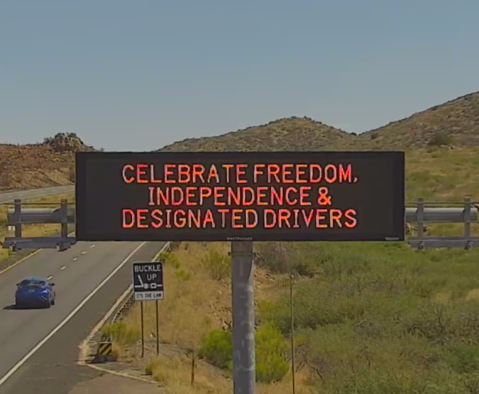 A digital message board on the highway encourages motorists to designate a driver.