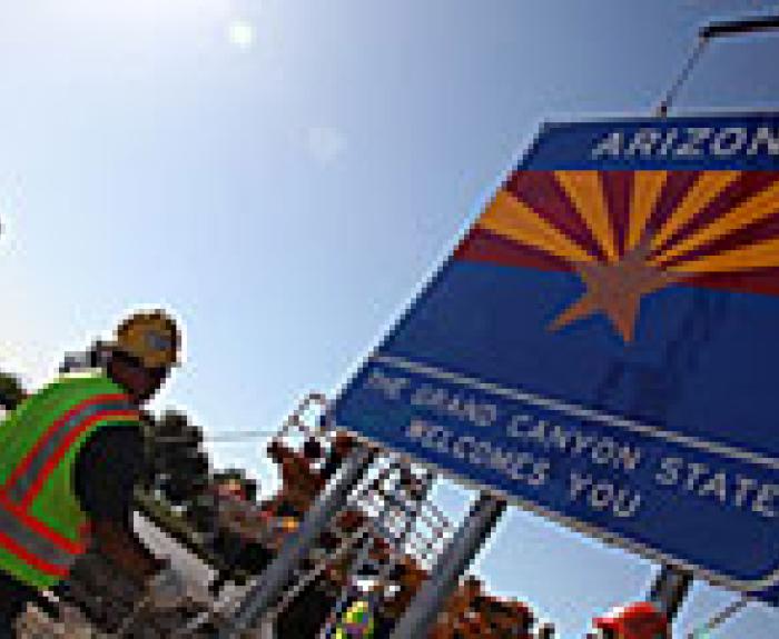 Putting up a Welcome to Arizona sign