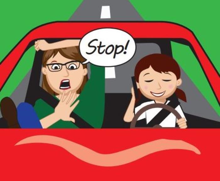"Stop!" Girl on phone while mother teaches how to drive.