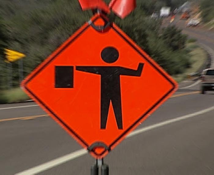 Flagger ahead road sign