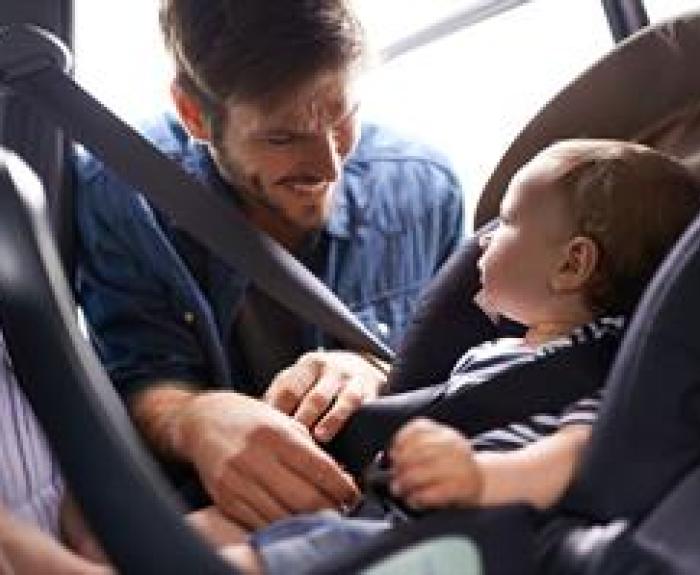 Putting child in car seat