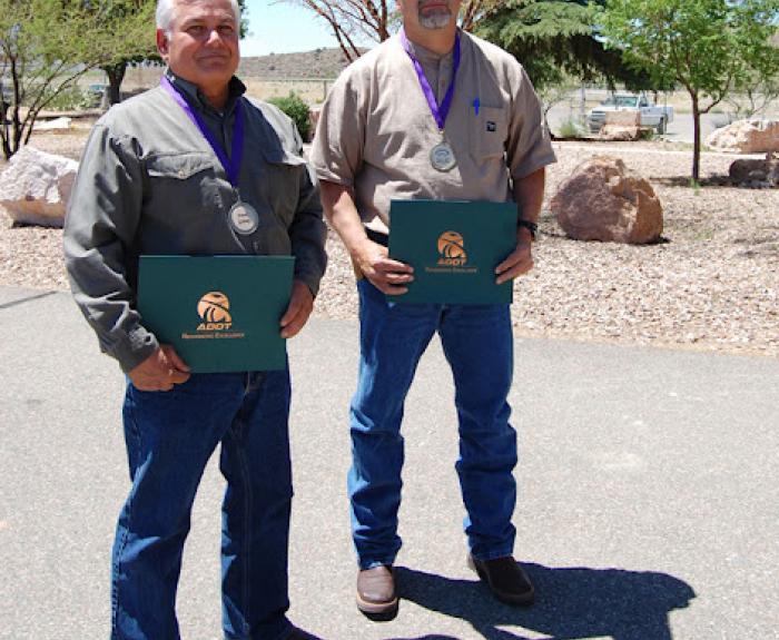 Frank Gidney and Lonnie Baca, right, accepting awards