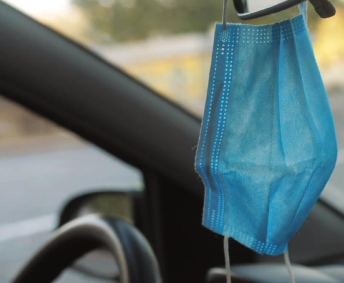Mask hanging from rear view mirror