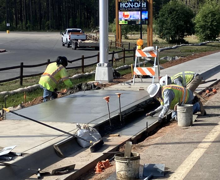 Workers add sidewalk along State Route 73