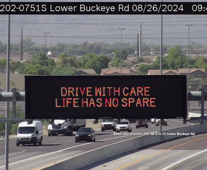 A digital message board on the highway encouraging drivers to drive with care