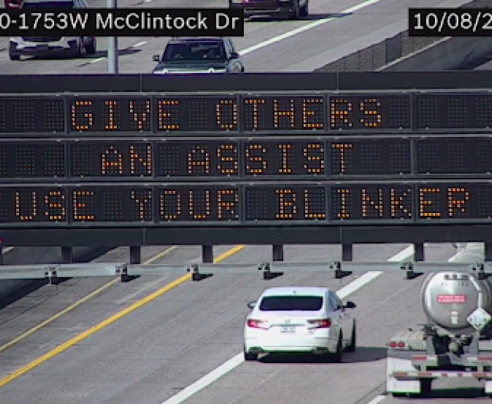 A digital message board on the highway encouraging drivers to use their blinkers