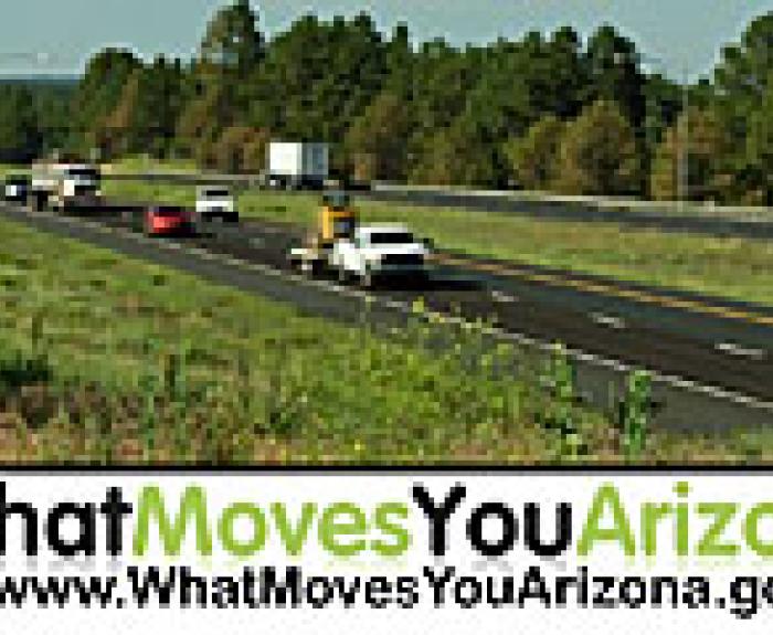 Extensive campaign sign - What Moves You Arizona is overlooking a highway traffic scenery
