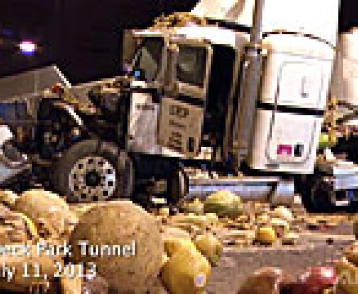 A crashed semi-truck surrounded by scattered produce in the Deck Park Tunnel on Interstate 10 in Phoenix Arizona.