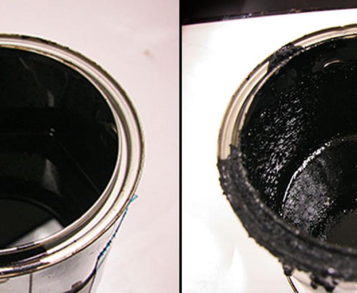 Cans holding old and new asphalt