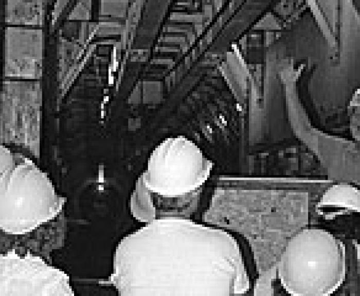Old photo of tunnel and people wearing hard hats