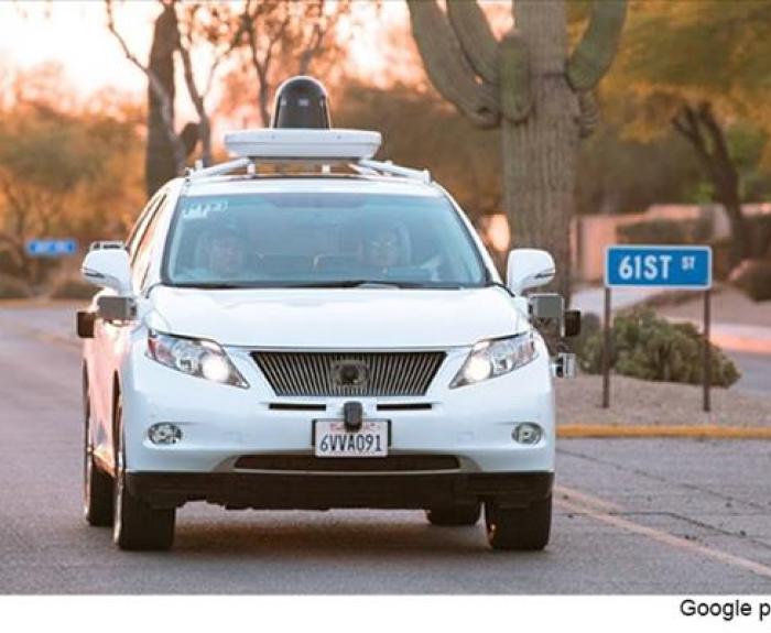 White Self-driving sedan front view on road