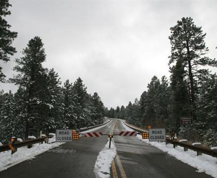 Road closed signs and barrier on State Route 67