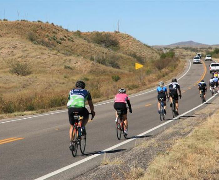 Bicycle riders on a rural highway.