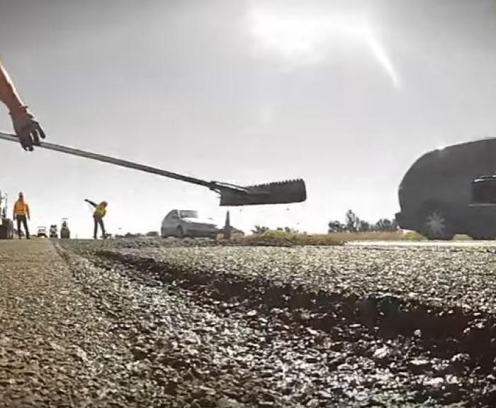 Workers laying asphalt