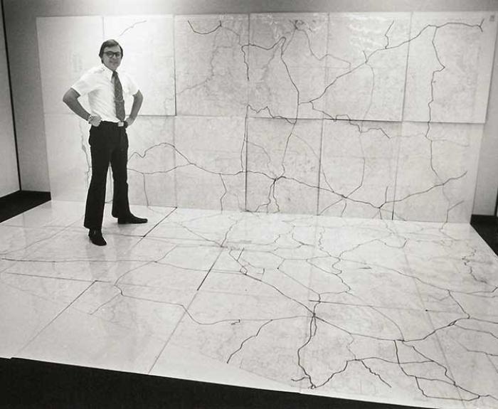 Man standing on large map on the floor and up the wall