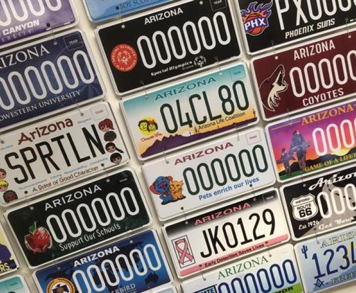 Various colorful Arizona specialty license plates are displayed together, featuring different themes and designs.