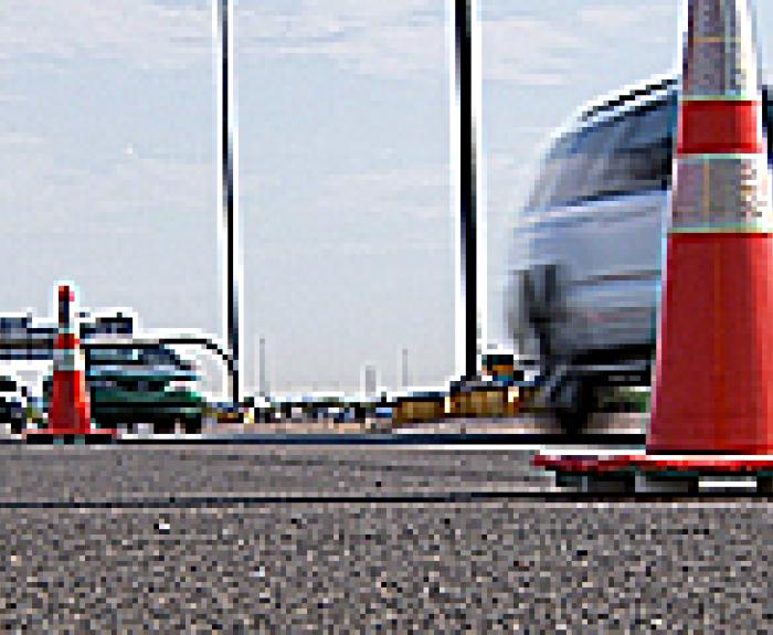 Traffic cones and cars on road
