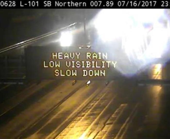 Image of DMS that reads "Heavy rain, Low visibility, Slow down" 