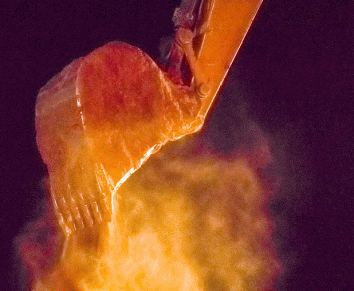 NIghttime dirt haul with dust reflecting orange light