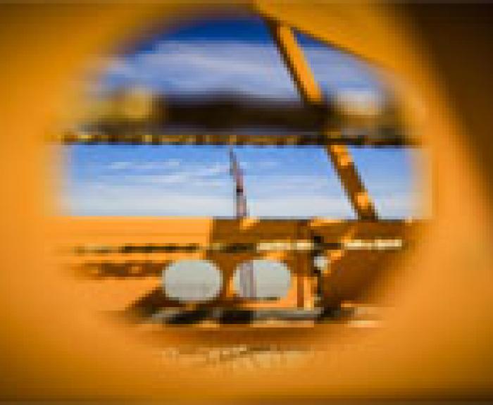 Crane lifting girders seen through hole of a bidwell