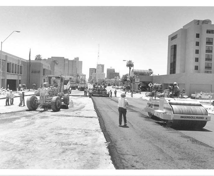 Black and white photo of road paving machines working on Central Avenue