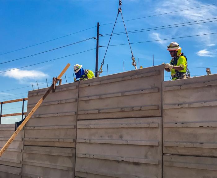 Workers build freeway soundwall amid extreme heat