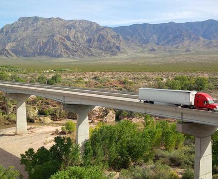Image of semi truck driving over I-15 bridge