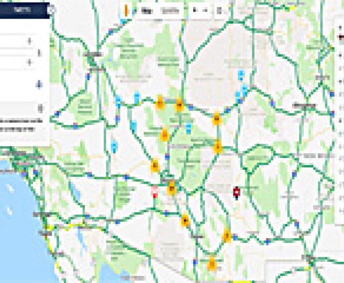 Screenshot of a digital traffic map showing roads, highways, and color-coded traffic conditions in Southern California, with icons for alerts and incidents.