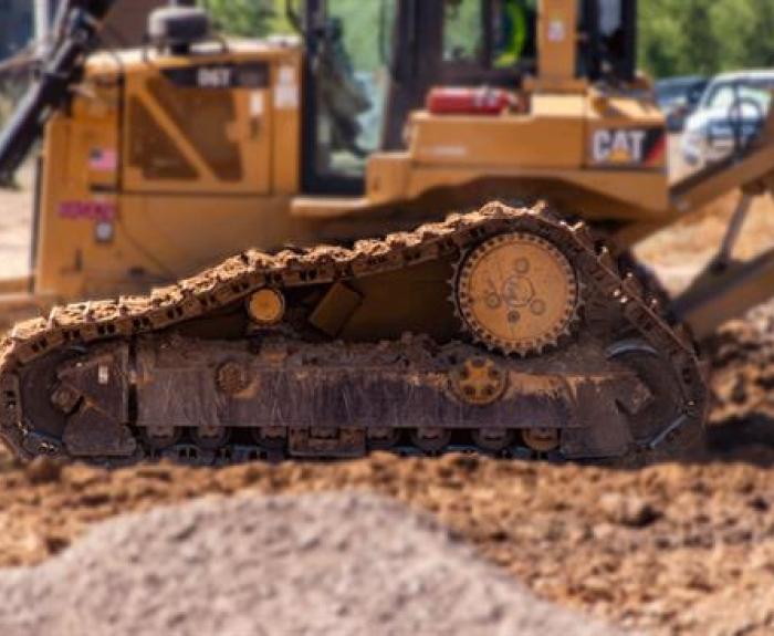 Earth mover vehicle in focus with dirt blurry