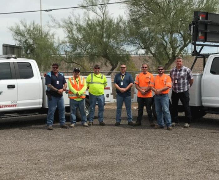 Incident Response Unit members pose with two trucks