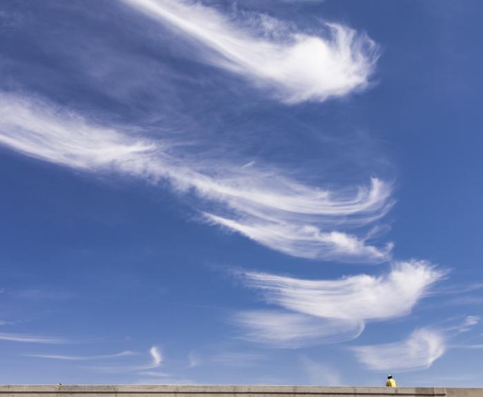 Cirrus clouds in sky about interchange bridge construction